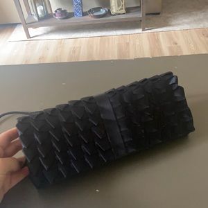 Black clutch with detailing on front